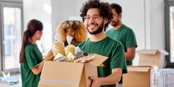 Non profit worker holding a box of food